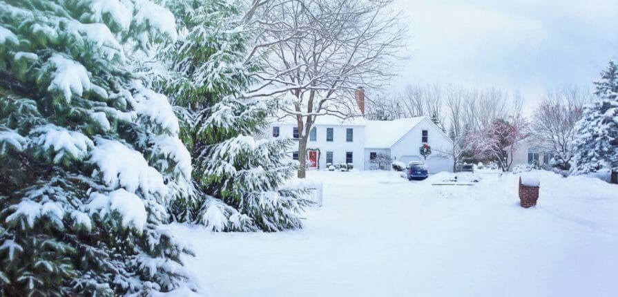 Minnesota winter landscape features a colonial styled home outfitted with Climate Seal Preservation Series to protect it from the harsh Minnesota winter weather.