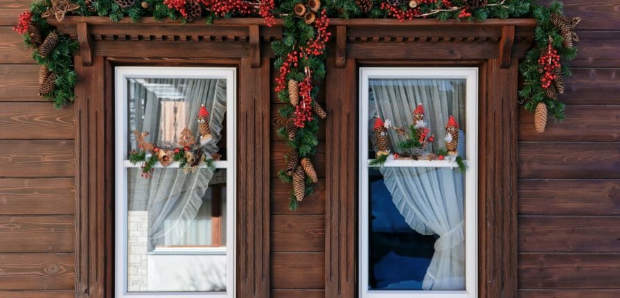 A wooden window decorated for Christmas features Climate Seal Thermal Window Inserts