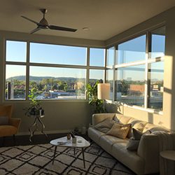A living room with corner windows on a sunny day