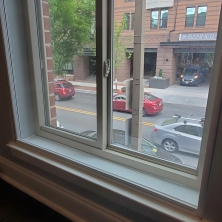An apartment window is equipped with Climate Seal acoustic series window insert reduce exterior noise from the city street below