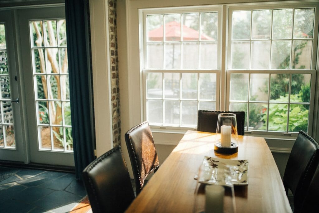 Climate Seal thermal window inserts blend seamlessly with interior molding in a well lit dining room.