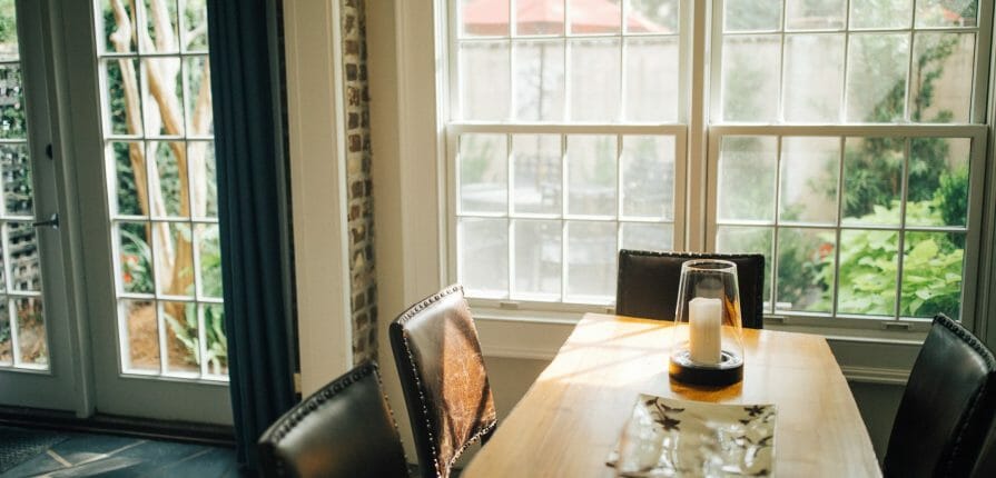 Climate Seal thermal window inserts blend seamlessly with interior molding in a well lit dining room.
