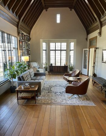 A living room in a historic building features ASI Climate Seal Preservation Series Windows and Window Inserts.